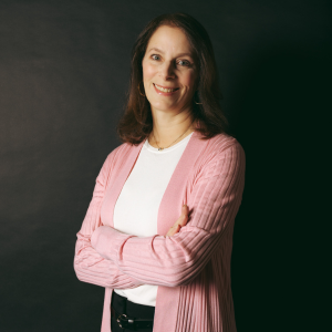 Karen Yannone smiling at the camera in a pink sweater 