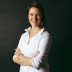 Louise Dawson smiling at the camera in a white blouse