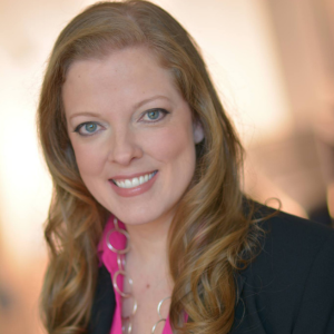 Patricia Robert smiling at the camera in a pink blouse