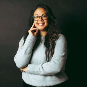 Sheela Banks smiling at the camera in a grey sweater