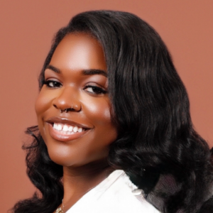 Taniya Boykin smiling at the camera in a white top