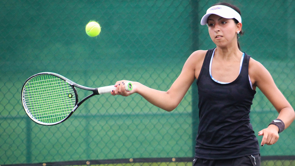 Female tennis player preparing to hit a tennis ball.