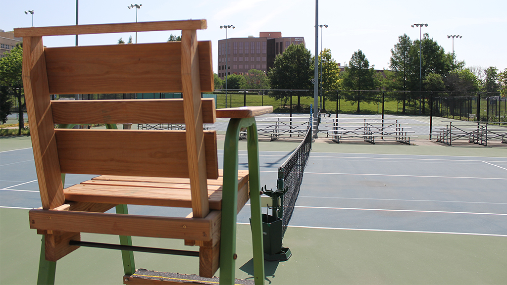 An officials chair on tennis court.