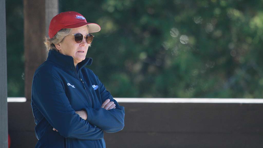 Woman USTA official looking at court