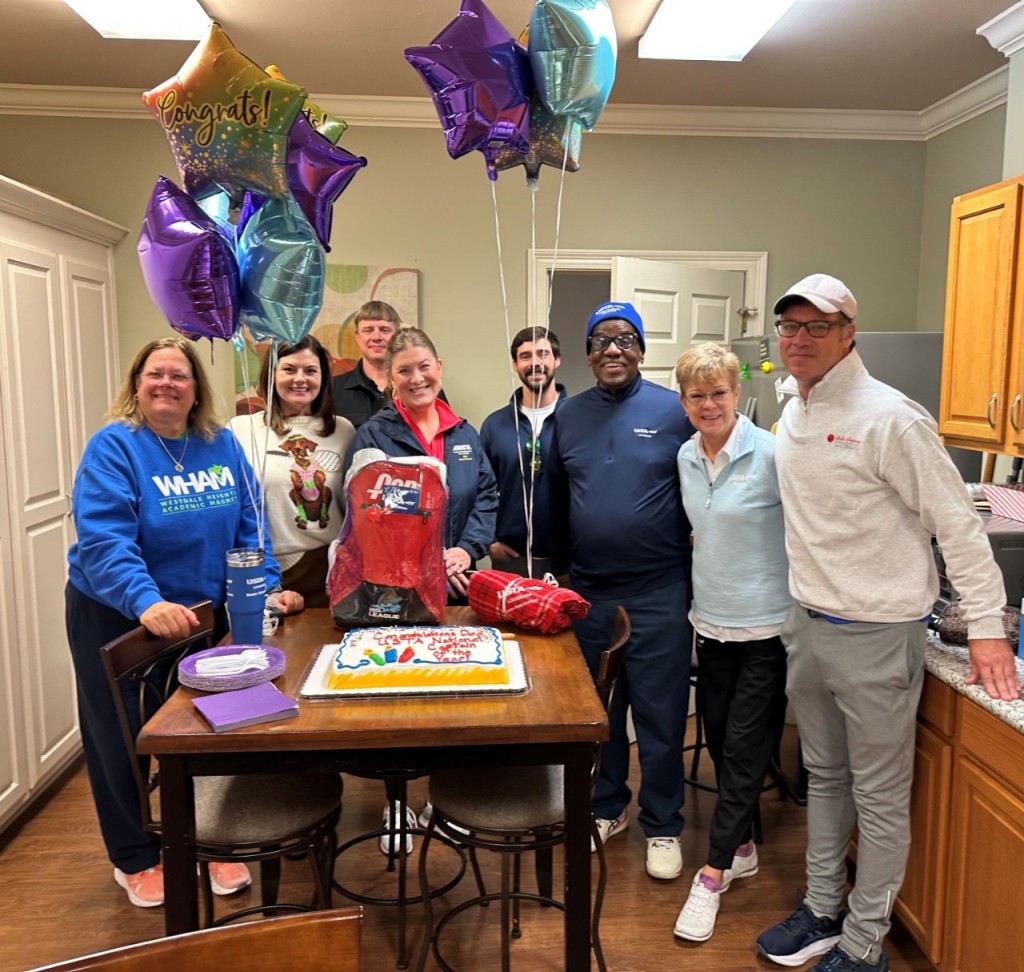 Wilbert "Doc" Whitfield (blue hat) is feted by members of the Baton Rouge tennis community after he was named USTA Captain of the Year.